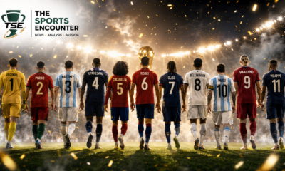 Back view of the 11 players selected in the fan-voted FIFA World Cup 2026 Dream Team walking toward the trophy under stadium lights.