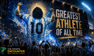 Wall mural of an iconic Argentina No. 10 footballer raising his arms as fans wave national flags beneath the slogan “Greatest Athlete of All Time,” with The Sports Encounter logo in the lower-left corner.