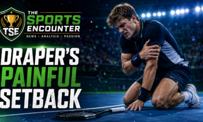 Cinematic VFX featured image showing a fictionalized British tennis player clutching his left arm in pain on a hard court, with The Sports Encounter logo and the headline “Draper’s Painful Setback.”