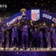 Los Angeles Knight Riders players lift the Major League Cricket trophy on the podium as fireworks and confetti mark their first MLC title in 2026.