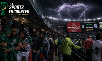 Soccer fans in rain ponchos take shelter at Estadio Azteca as a severe storm approaches before Mexico vs England at World Cup 2026.