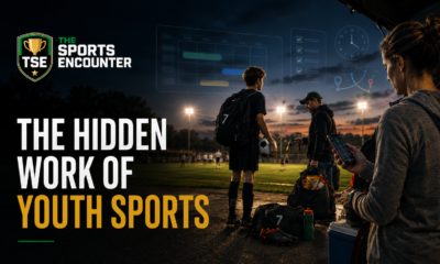 Youth soccer player stands beside a floodlit field while parents manage schedules, transportation, equipment, and team coordination.