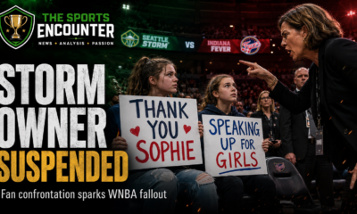 Two teenage fans hold signs supporting Sophie Cunningham as a Seattle Storm co-owner confronts them during a WNBA game, illustrating the incident that led to her suspension.
