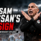 Hossam Hassan makes a crossed-arm X gesture during Egypt’s controversial World Cup match against Argentina, with VAR and refereeing tension highlighted in the background.