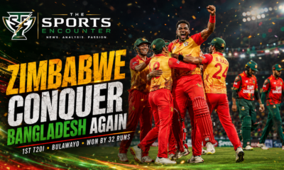 Zimbabwe players in red-and-gold kits celebrate their 32-run T20I win over Bangladesh under stadium lights, with The Sports Encounter logo and bold victory headline.