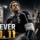 Anze Kopitar in a black No. 11 hockey uniform stands beneath arena lights beside a retired jersey banner and bronze statue, honoring his 20-season Los Angeles Kings career, two Stanley Cups and permanent franchise legacy.