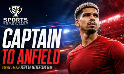 Ronald Araújo appears in a red Liverpool-style kit under dramatic stadium lights beside the headline “Captain to Anfield,” illustrating the Barcelona captain’s reported season-long loan move to Liverpool.