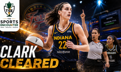 Caitlin Clark drives the ball for the Indiana Fever as a referee signals during the disputed call later rescinded by the WNBA, with “Clark Cleared” highlighting her avoided suspension.
