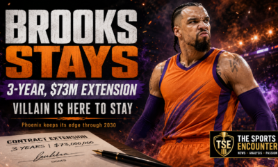 Cinematic Dillon Brooks contract-extension graphic showing a defiant basketball forward in a generic orange-and-purple uniform inside a fiery arena, with a signed three-year, $73 million contract, the headline “Brooks Stays,” the message “Villain Is Here to Stay,” and The Sports Encounter logo.