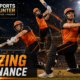 Three orange-clad cricket batters unleash powerful shots under stadium floodlights as blue-uniformed opponents look on, with fiery VFX effects, The Sports Encounter logo, and the punchline “Blazing Dominance.”