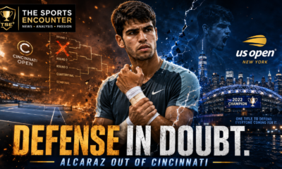 Carlos Alcaraz holds his taped wrist between a fiery Cincinnati Open court and a blue US Open stadium backdrop, with The Sports Encounter logo and the headline “Defense in Doubt.”