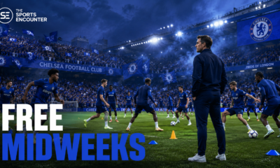 Xabi Alonso watches Chelsea players train at Stamford Bridge as cheering fans fill the stands, highlighting the club’s advantage of free midweeks without European football.