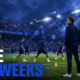 Xabi Alonso watches Chelsea players train at Stamford Bridge as cheering fans fill the stands, highlighting the club’s advantage of free midweeks without European football.