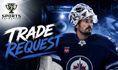 Connor Hellebuyck in Winnipeg Jets colors as his trade request raises major questions about the franchise’s future.
