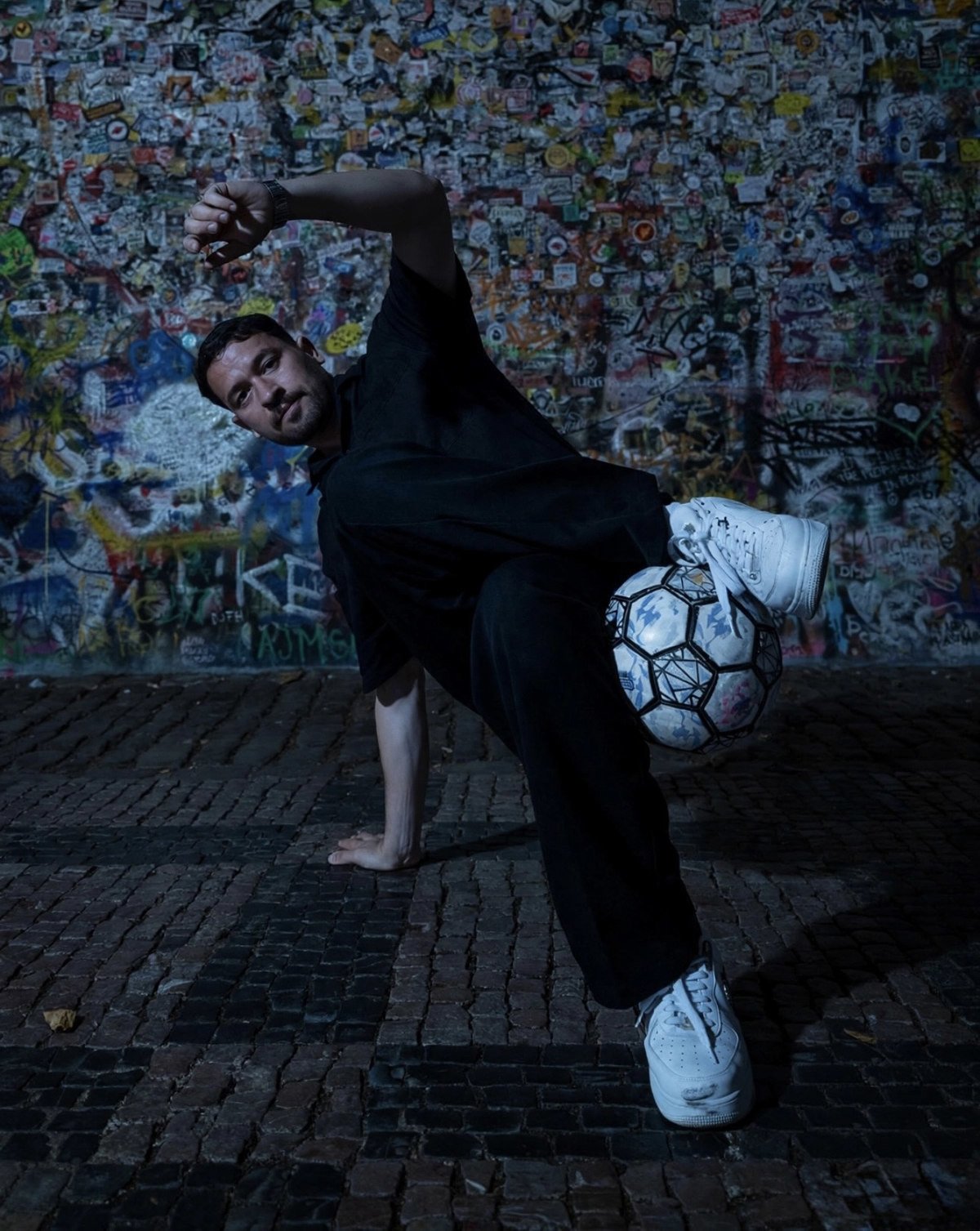 Faraj Rahil performing football skills next to an urban wall