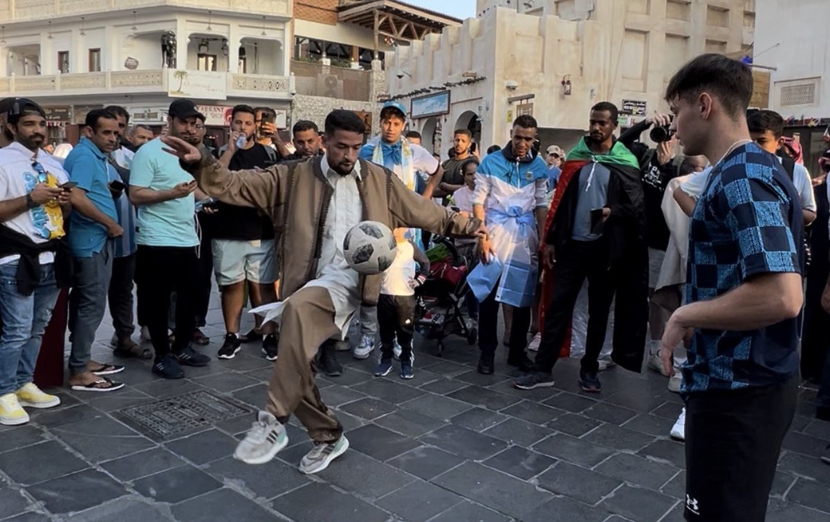 Faraj Rahil juggling a ball as spectators watch