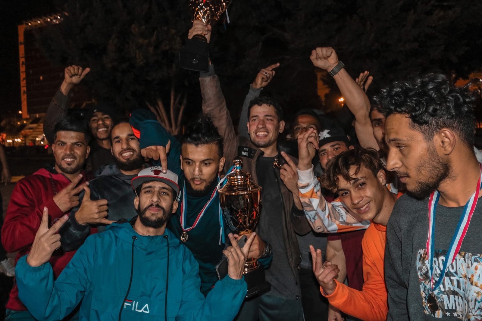 Faraj Rahil and other athletes celebrating with trophies and medals