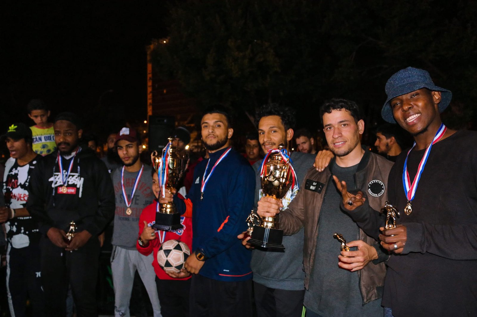 A group of freestyle football athletes with medals and trophies including Faraj Rahil