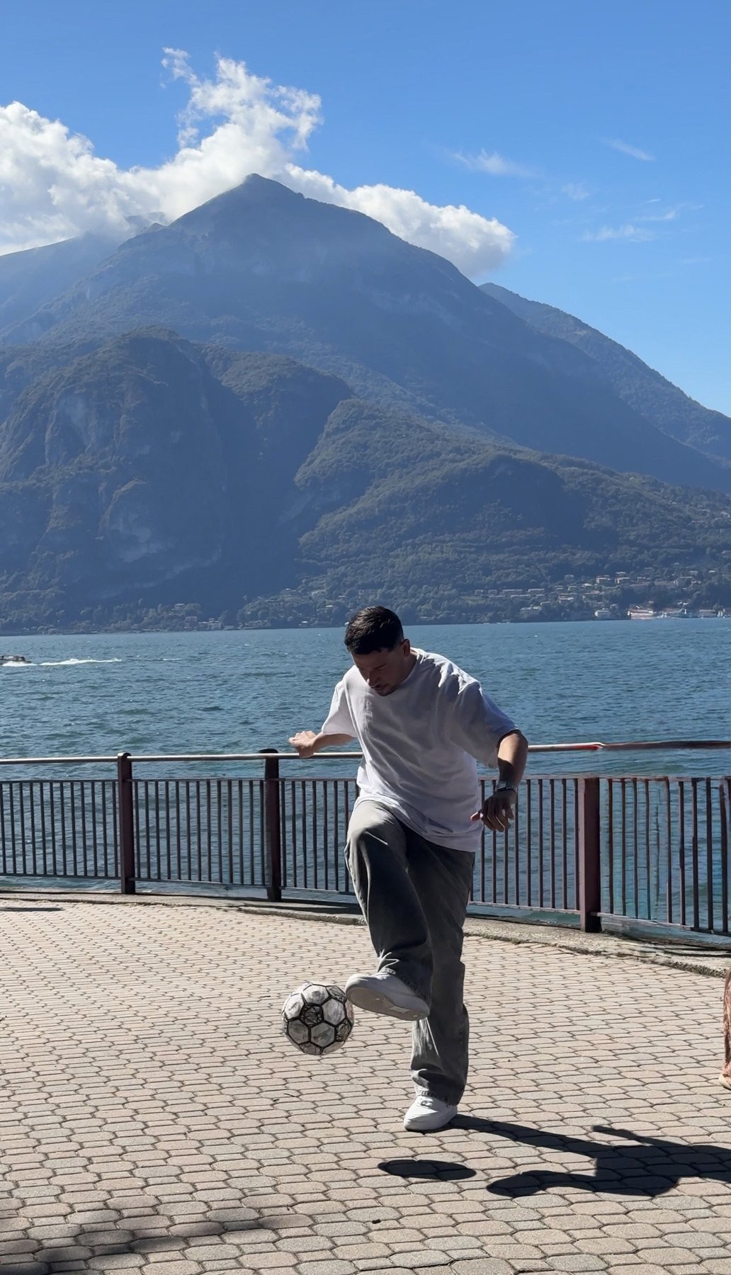 Faraj Rahil performing a ball-control trick beside a mountain lake